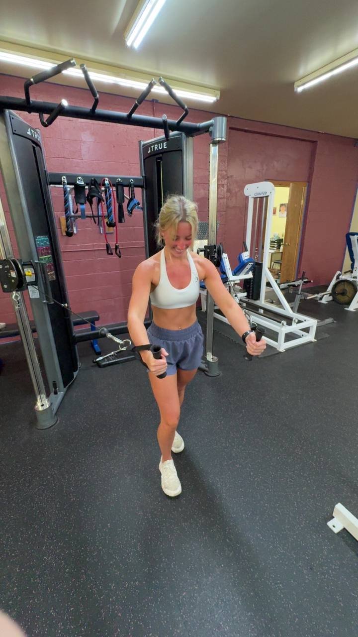 A member training on the cable crossover station at Summit Quest